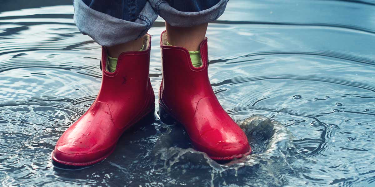 Woman wearing rubber boots because of a basement flood
